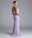 Turn heads at Prom 2025 in this lavender prom dress, where statement-making details meet the iconic style of the Madison Cowl Neck Slit Glitter Formal Dress.