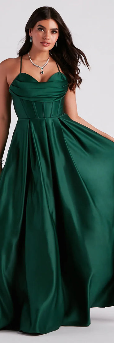 Turn heads at HOCO 2025 in this hunter green homecoming dress, where statement-making details meet the iconic style of the Kayla Satin Cowl A-Line Ball Gown .