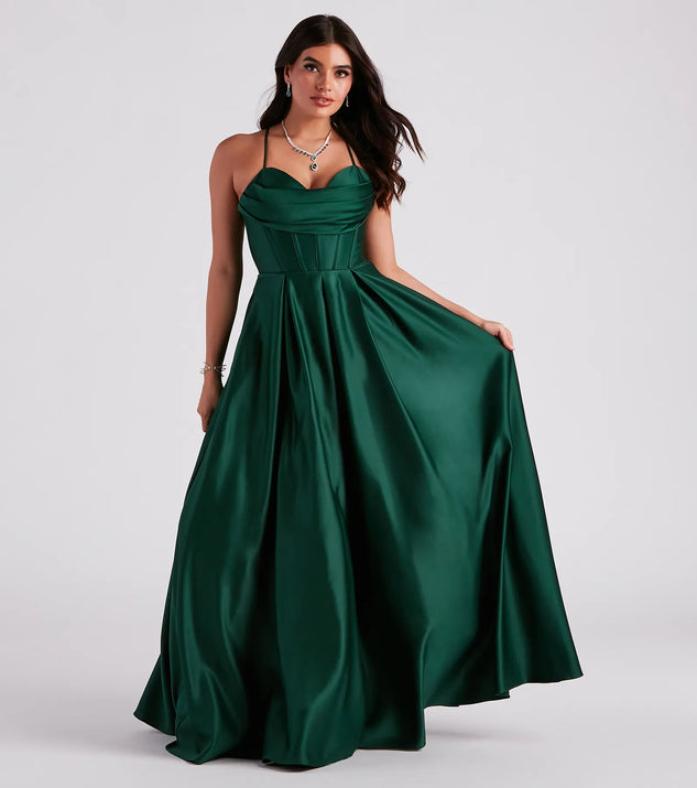 Turn heads at Prom 2025 in this hunter green prom dress, where statement-making details meet the iconic style of the Kayla Satin Cowl A-Line Ball Gown .