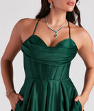 Step into Prom 2025 in a hunter green prom dress, where unique Windsor accents and the standout Kayla Satin Cowl A-Line Ball Gown style come together.