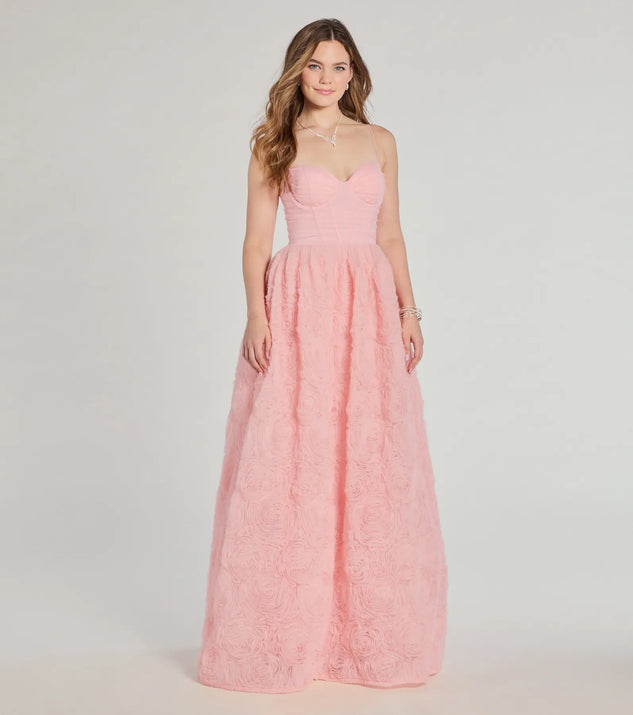 The Jayla Floral Rosette A-Line Ball Gown in luxe pink fabric, a stunning prom dress with statement details designed to make a bold impression at Prom 2025.