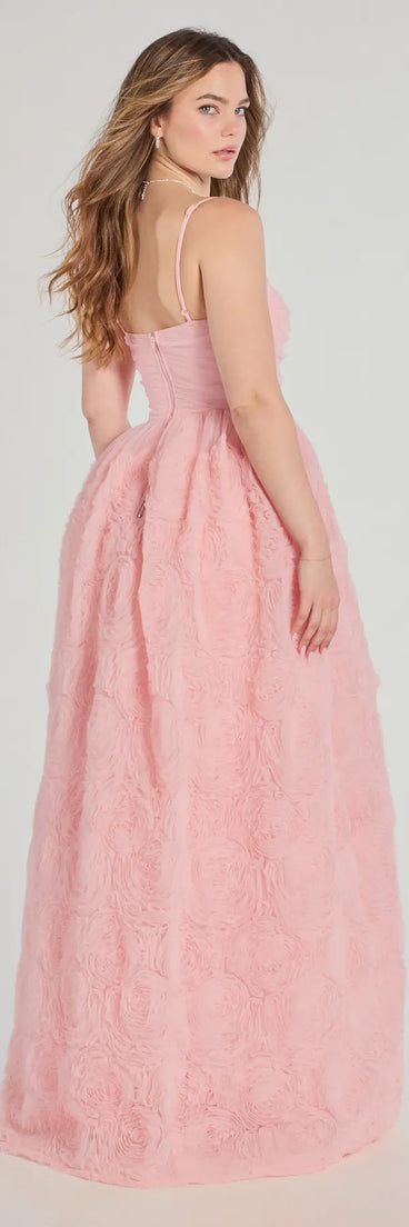 The Jayla Floral Rosette A-Line Ball Gown in luxe pink fabric, a stunning prom dress with statement details designed to make a bold impression at Prom 2025.