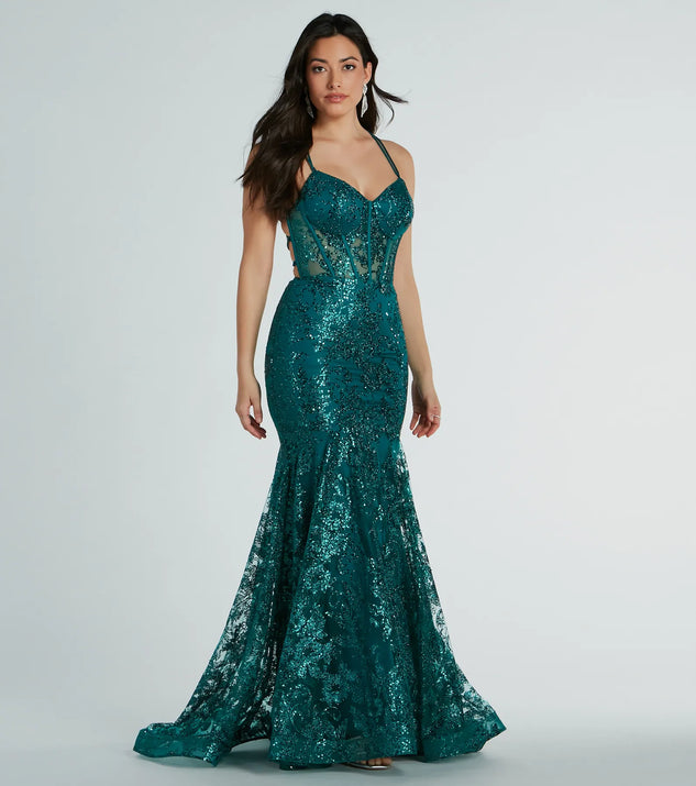 Make a bold statement in the Amal Bustier Lace-Up Mermaid Glitter Sequin Gown in hunter green, the perfect green dress for weddings, cocktail hours, nights out, and/or seasonal celebrations.