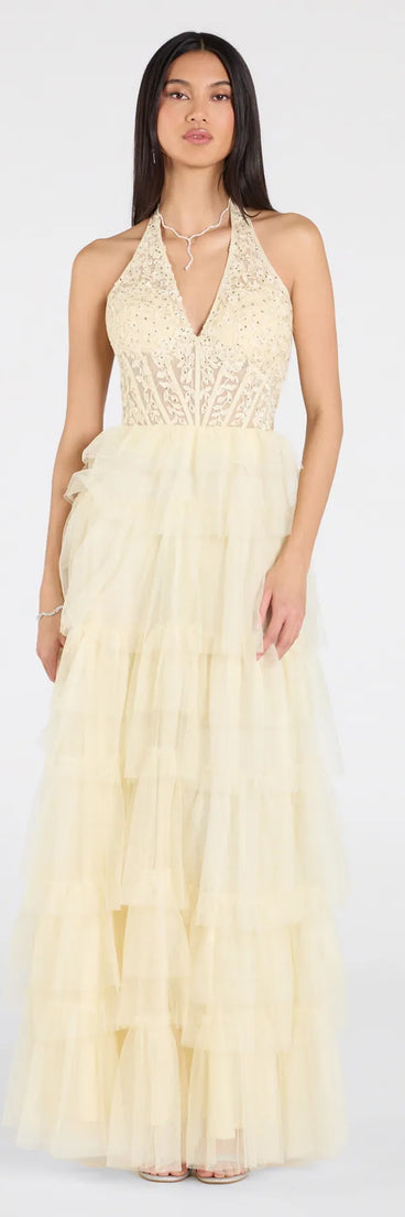 Feel instantly put-together in the Bristol Floral Applique Ruffled Tulle Ball Gown in yellow, a summer wedding guest dress designed for confident style and all-out celebration.