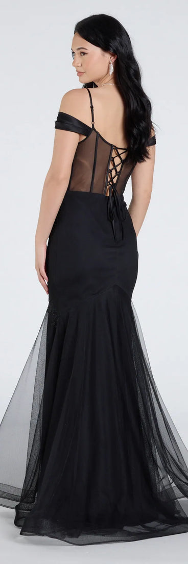 The Cleo Floral Embroidered Tulle Corset Mermaid Gown is a show-stopping black prom dress, offering a sleek, slimming silhouette that enhances your natural beauty for an unforgettable night.