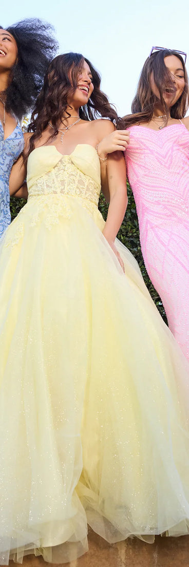 Make a bold statement in the Gwen Strapless Corset A-Line Glitter Ball Gown in yellow, the perfect summer dress for weddings, cocktail hours, nights out, and/or seasonal celebrations.