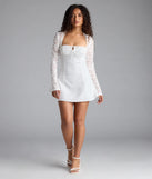Feel confident and photo-ready in the Flirty Factor Lace Long Sleeve Crepe Mini Dress, a white graduation dress perfect for 2025 ceremonies and parties.