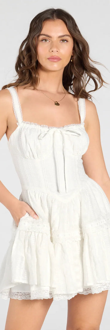 Feel confident and photo-ready in the Playful Flirt Lace-Up Ruffle Skater Dress, a white graduation dress perfect for 2025 ceremonies and parties.