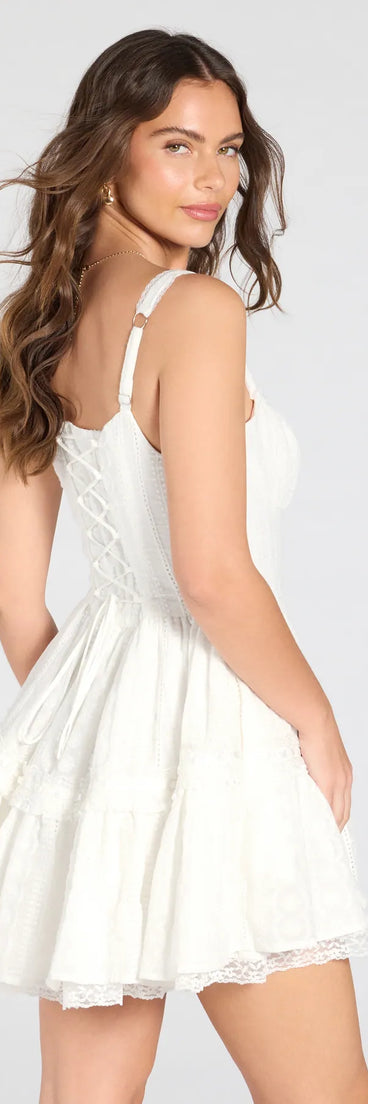 Make a bold statement in the Playful Flirt Lace-Up Ruffle Skater Dress in white, the perfect spring dress for weddings, cocktail hours, nights out, and/or seasonal celebrations.