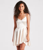 Step into winter chic with the Dancing Diva Satin Skater Dress, a ivory mini dress featuring an above-the-knee cut ideal for cocktail parties, festive gatherings, or clubwear.