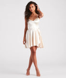 The Dancing Diva Satin Skater Dress is a stunning ivory mini dress with a short hem, designed to be the perfect winter cocktail dress or night-out look for the holiday season.