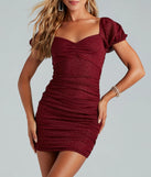 Step into winter chic with the Unreal Shine Glitter Puff Sleeve Mini Dress, a burgundy mini dress featuring an above-the-knee cut ideal for cocktail parties, festive gatherings, or clubwear.
