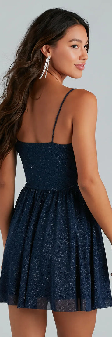 The Ready To Shine Glitter Short Skater Dress is a mini dress in navy, perfect for an above-the-knee holiday party dress or a stylish NYE look, with a short hemline designed to make a winter statement.