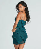 Revamp your 2025 wardrobe with this chic addition, the Glam Status Ruffled Glitter Mesh Mini Dress in hunter green, perfect for elevating your style in the new year.
