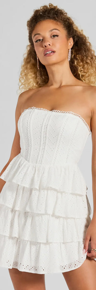 Essential for vacations or summer days, the Sweetest Sight Strapless Ruffled Eyelet Mini Dress is a sundress or milkmaid dress with sleek and flirty details.