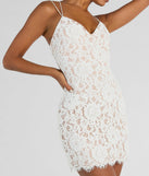 Step into winter chic with the Major Swoon Strappy Back Lace Mini Dress, a white mini dress featuring an above-the-knee cut ideal for cocktail parties, festive gatherings, or clubwear.