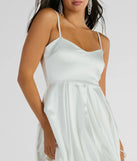 Step into winter chic with the Lavish Flirt V-Neck Bubble Hem Skater Satin Dress, a white mini dress featuring an above-the-knee cut ideal for cocktail parties, festive gatherings, or clubwear.