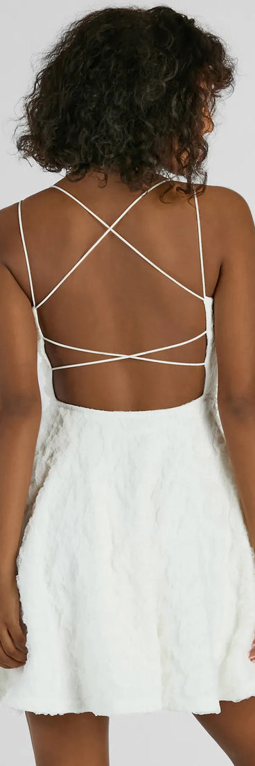 The Whimsical Beauty Strappy Back Textured Knit Skater Dress is a mini dress in white, perfect for an above-the-knee holiday party dress or a stylish NYE look, with a short hemline designed to make a winter statement.