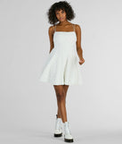 The Whimsical Beauty Strappy Back Textured Knit Skater Dress is a stunning white mini dress with a short hem, designed to be the perfect winter cocktail dress or night-out look for the holiday season.