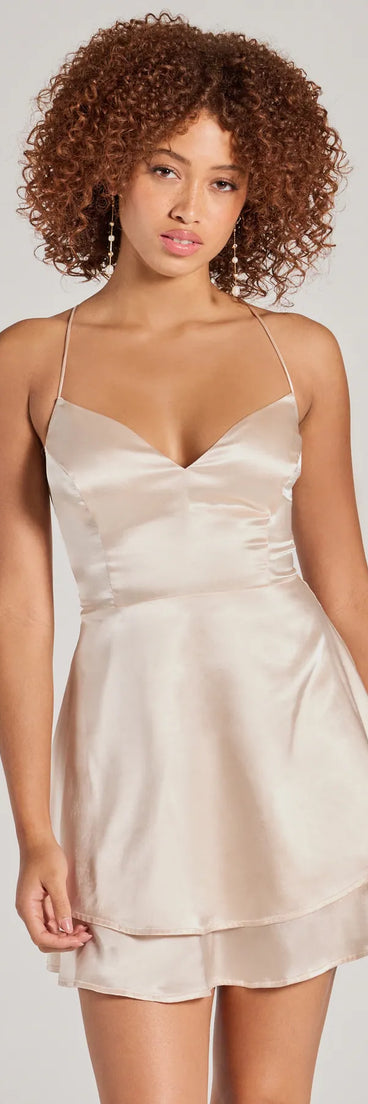 Step into winter chic with the Captivating Charm Sleeveless Satin Tiered Skater Dress, a gold mini dress featuring an above-the-knee cut ideal for cocktail parties, festive gatherings, or clubwear.