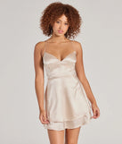 Step into winter chic with the Captivating Charm Sleeveless Satin Tiered Skater Dress, a gold mini dress featuring an above-the-knee cut ideal for cocktail parties, festive gatherings, or clubwear.