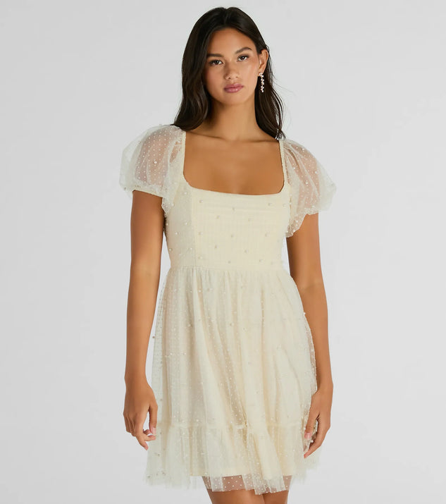 The Raise A Toast Puff Sleeve Faux Pearl Babydoll Dress is a mini dress that will make a statement with its short hemline and on-trend details to have you ready for any event!