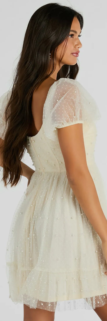 The Raise A Toast Puff Sleeve Faux Pearl Babydoll Dress is a mini dress that will make a statement with its short hemline and on-trend details to have you ready for any event!