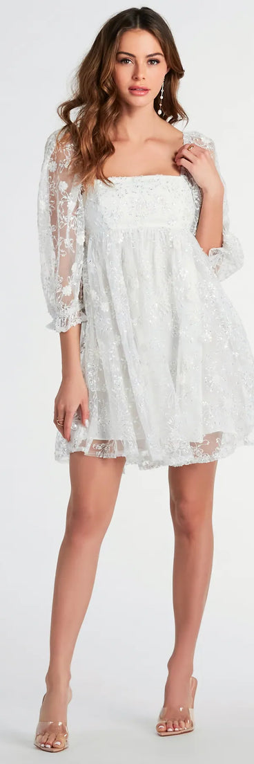 The Beautiful Bliss Floral Sequin Mesh Babydoll Dress is a mini dress in ivory, perfect for an above-the-knee holiday party dress or a stylish NYE look, with a short hemline designed to make a winter statement.