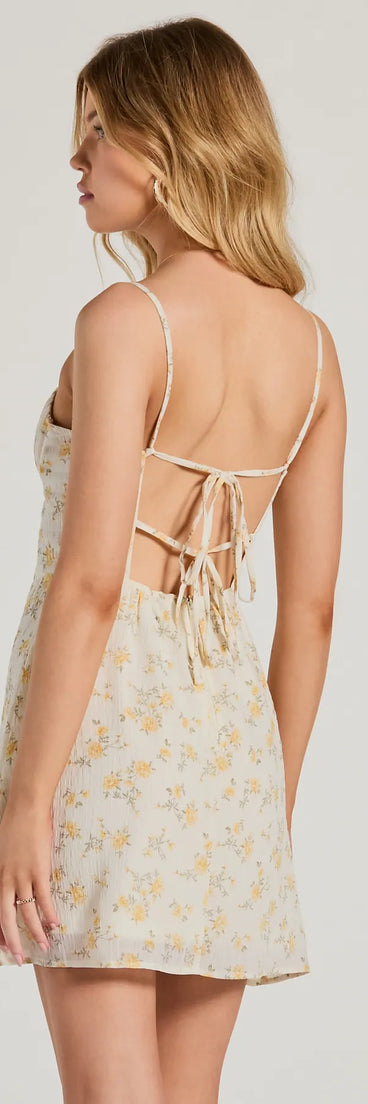 The Ultimate Chic Choice Floral Tie-Back Short Dress is a mini dress in ivory, perfect for an above-the-knee holiday party dress or a stylish NYE look, with a short hemline designed to make a winter statement.