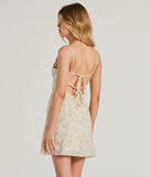 The Ultimate Chic Choice Floral Tie-Back Short Dress is a mini dress in ivory, perfect for an above-the-knee holiday party dress or a stylish NYE look, with a short hemline designed to make a winter statement.