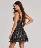 The Starry Night Glitter Tulle Skater Dress is a mini dress in black, perfect for an above-the-knee holiday party dress or a stylish NYE look, with a short hemline designed to make a winter statement.