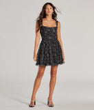 The Starry Night Glitter Tulle Skater Dress is a stunning black mini dress with a short hem, designed to be the perfect winter cocktail dress or night-out look for the holiday season.