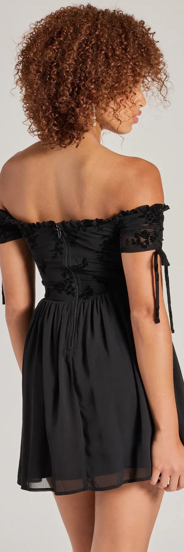 The Radiating Luxe Flocked Velvet Skater Dress is a stylish black floral dress featuring a fresh seasonal print and flattering design, perfect for garden parties, bridal showers, Valentine's Day celebrations, or everyday spring styling.