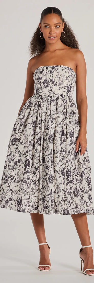 The stunning Into The Floral Forest Strapless A-Line Midi Dress provides a chic silhouette and party-ready details that make it a standout black dress for cocktail events, New Year's Eve parties, or as a winter wedding guest look.
