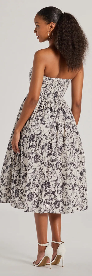 The stunning Into The Floral Forest Strapless A-Line Midi Dress provides a chic silhouette and party-ready details that make it a standout black dress for cocktail events, New Year's Eve parties, or as a winter wedding guest look.