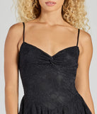 The Adorable Muse Ruffled Lace Skater Dress is a stylish black lace dress, designed with intricate lace and an alluring silhouette, making it an elegant choice for graduation photoshoots, weddings, or effortless summer looks.