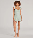 Shine with confidence, elegance, and standout style in the Enchanting Impression Butterfly Lace-Up Skater Dress—a sage green graduation dress designed with a fresh silhouette and the latest trends.