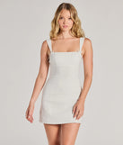 Feel confident and photo-ready in the Effortless And Chic Bow Trim Mini Dress, a white graduation dress perfect for 2025 ceremonies and parties.