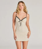 The Delicate Love Bow V-Neck Lace Mini Dress is a stylish ivory lace dress, designed with intricate lace and an alluring silhouette, making it an elegant choice for Valentine's Day, weddings, or effortless spring looks.