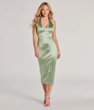 Turn heads at Prom 2025 in this sage green prom dress, where statement-making details meet the iconic style of the Celebrate Love Halter V-Neck Bodycon Satin Midi Dress .