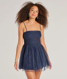 Turn heads at Prom 2025 in this navy blue prom dress, where statement-making details meet the iconic style of the Major Stunner Tulle and Pearl Skater Dress .