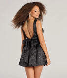 The Glitzy Chic Sequin Woven Drop Waist Skater Dress is a stylish black floral dress featuring a fresh seasonal print and flattering design, perfect for garden parties, bridal showers, grad parties, or everyday spring styling.