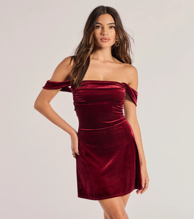 The Flirty And Chic Velvet Off-The-Shoulder Mini Dress in wine is a modern red dress featuring trendy details and a stunning design ideal for wedding guest dresses, elegant cocktail looks, or an alluring Valentine’s Day dress.