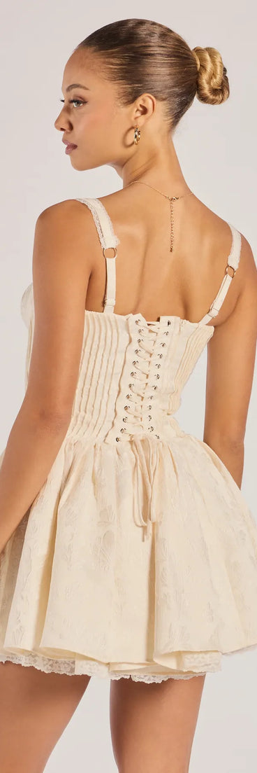 Own your moment in the Flirt It Up Floral Jacquard Satin Corset Skater Dressin ivory, a standout 2025 Homecoming Dress that captures all the glam and energy of the night.