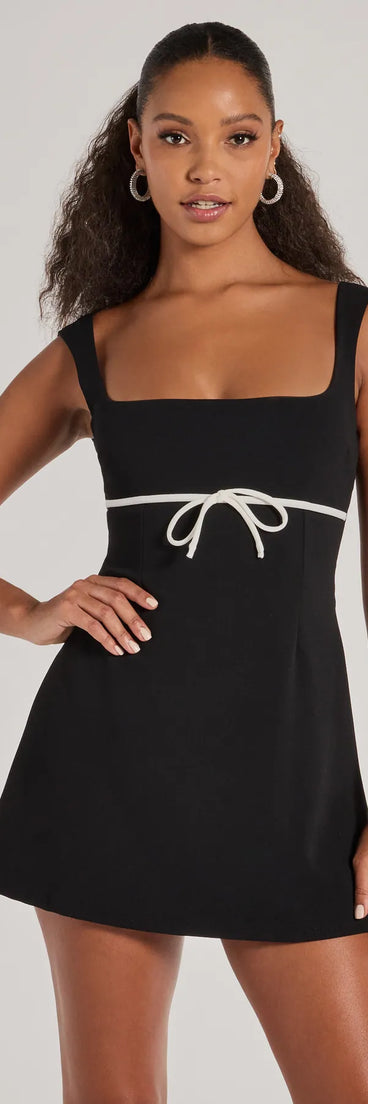 Step into winter chic with the So Adored Sleeveless Bow Trim Crepe Mini Dress, a black mini dress featuring an above-the-knee cut ideal for cocktail parties, festive gatherings, or clubwear.