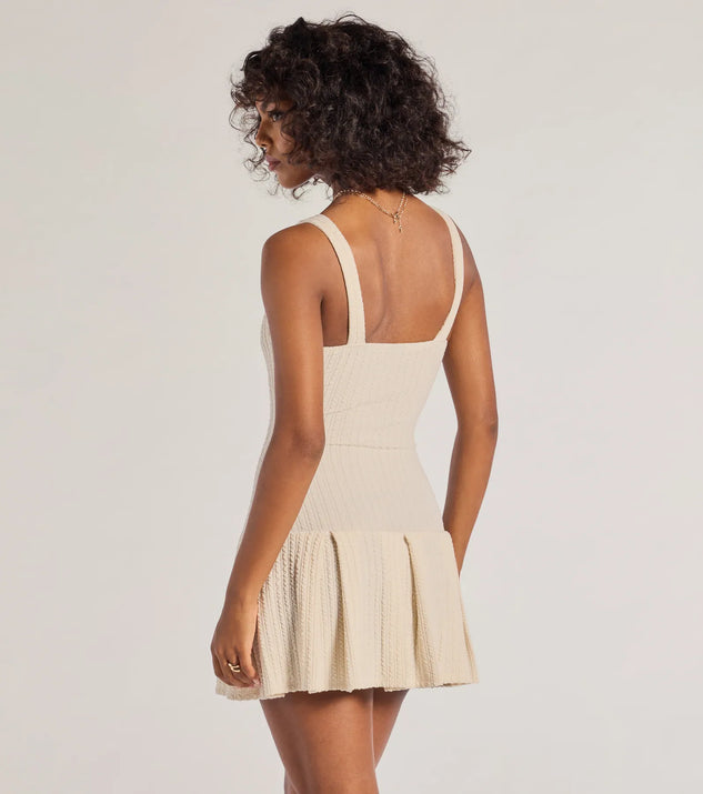 Elevated Button-Down Drop Waist Mini Dress, a trendy ivory mini dress featuring modern details and a fresh seasonal hue, perfect for creating chic 2025 looks.