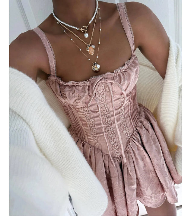 Make a bold statement in the Flirt It Up Floral Jacquard Satin Corset Skater Dress in mauve, the perfect summer dress for weddings, cocktail hours, nights out, and/or seasonal celebrations.