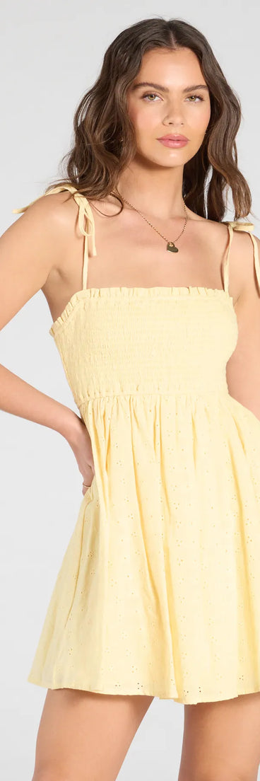Feel confident and photo-ready in the Sunny Tones Smocked Eyelet Skater Dress, a yellow graduation dress perfect for 2025 ceremonies and parties.