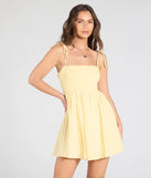 Feel confident and photo-ready in the Sunny Tones Smocked Eyelet Skater Dress, a yellow graduation dress perfect for 2025 ceremonies and parties.