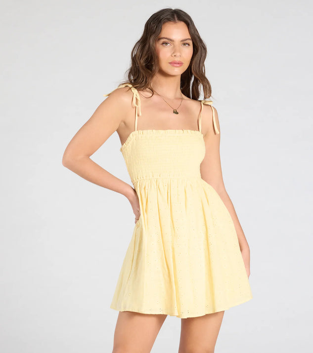 Feel confident and photo-ready in the Sunny Tones Smocked Eyelet Skater Dress, a yellow graduation dress perfect for 2025 ceremonies and parties.